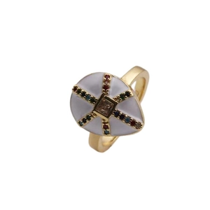 Macro detail of 18K gold ring with white enamel, champagne stone and colored zircons