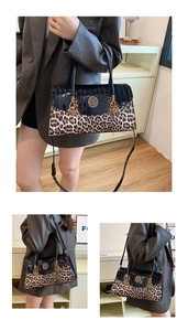Detail of leopard print and crocodile texture bag with golden lion head emblem