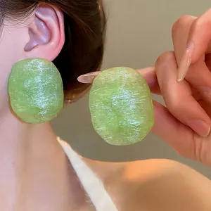 Textured light green oval resin earrings with matte finish and elegant silver pins