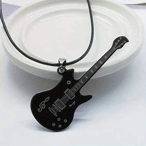 Fashionable black electric guitar pendant necklace on minimalist ceramic display