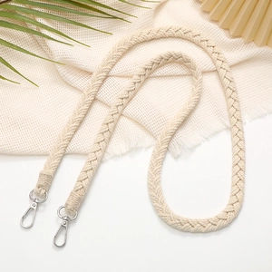 Beige hand-woven crossbody phone strap with metal clasps on white background