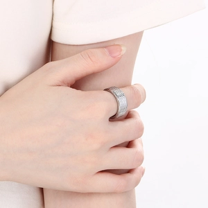 Detail shot of vintage silver woven diamond pattern ring on hand with clear texture