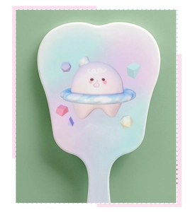 Close-up of a tooth-shaped white handheld makeup mirror with a cute cartoon character