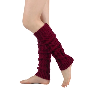 Close-up of thick cable knit leg warmers in deep wine red showing textured knit pattern