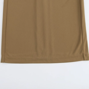 Detail view showing textured brown knit fabric and stitching on sleeveless dress hem