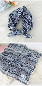 Detail of navy blue cotton linen scarf with geometric patterns and white lace trim