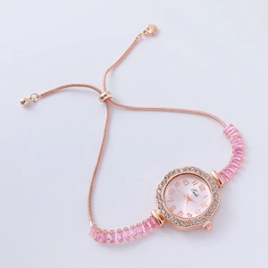 Detail of rose gold square watch featuring pink gemstones and crystal-encrusted bracelet