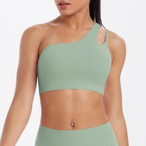Detail view of the asymmetric one-shoulder yoga bra with cutout design and smooth texture
