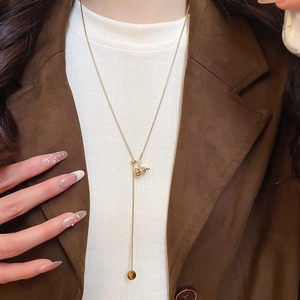 Tiger eye stone gourd pendant necklace shown on model with brown blazer and white knitwear