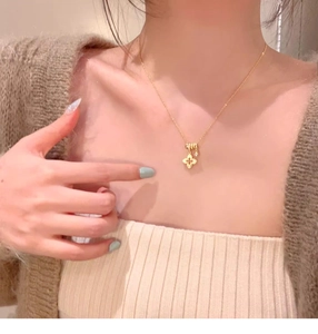 Detail of vintage gold floral pendant necklace shown on collarbone for everyday wear