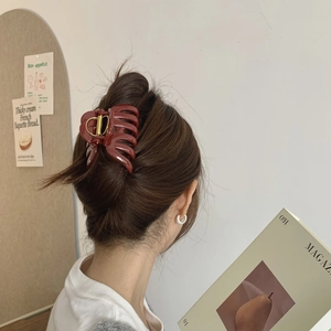 Elegant burgundy large hair claw clip for women shown in a stylish updo hairstyle