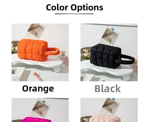 Detailed grid view showing orange, black, and pink quilted puffer cosmetic bags with handles