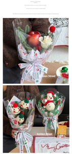 Detail of Christmas bouquet with knit snowmen, faux apple, and Merry Christmas ribbon