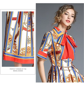 Detail of colorful baroque floral print fabric and red bow tie neckline on the dress