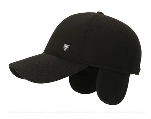Detail of winter baseball cap with ear flaps and silver shield logo in black twill
