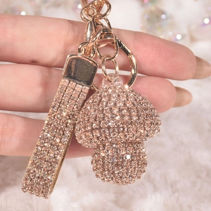 Detail view of rose gold rhinestone mushroom keychain with sparkling crystal wrist strap