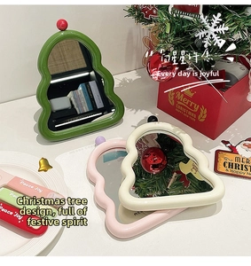 Detailed close-up of wavy Christmas tree-shaped desktop mirrors in assorted festive colors