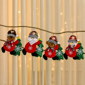 Set of four Christmas plush ornaments featuring reindeer, Santa, teddy bear and snowman dolls