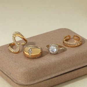 Set of four gold-plated irregular stainless steel rings with sparkling diamond accents
