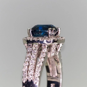 Luxurious silver ring with large blue zircon center stone and triple row of pave crystals