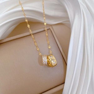 Titanium steel necklace featuring double rings with paved crystals on a golden chain