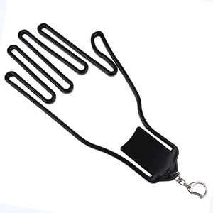 Black golf glove stretcher with rotating metal hook and clip for shape maintenance
