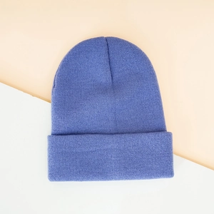 Detailed close-up of periwinkle blue ribbed knit beanie with stylish folded cuff