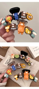 Macro detail of cute resin cartoon animal hair clips and chocolate donut claw clip