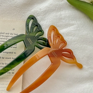 Elegant acetate butterfly hair pins in amber and dark green with handmade engraving
