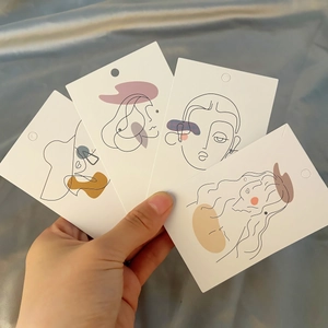 Minimalist white paper earring display cards featuring artistic female line art designs