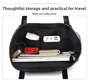 Top view of large black leather tote bag interior showing organized storage compartments