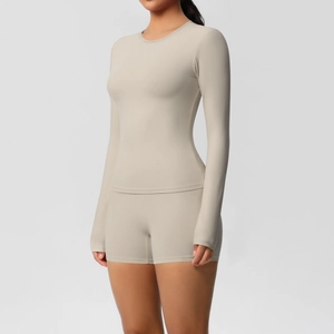 Detail of sand-colored double-sided brushed yoga set with long sleeve top and tight shorts