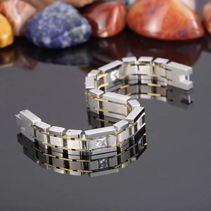 Macro view of two-tone stainless steel bracelet with square cubic zirconia inlays