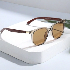 Detail view of tea-tinted lenses and dark brown wood-grain temples with metal studs