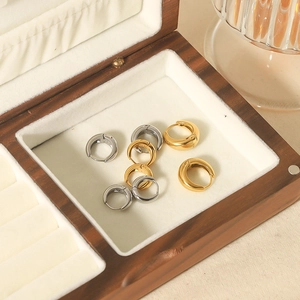 Polished U-shaped gold and silver stainless steel hoop earring set in wood jewelry box