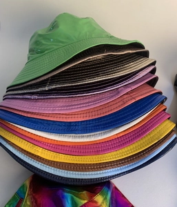 Detailed view of colorful glossy patent leather bucket hats in various vibrant metallic colors