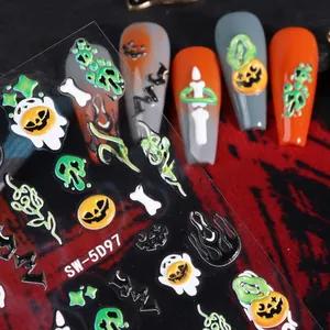 Macro view of 5D embossed Halloween nail art stickers with pumpkin and skull textures