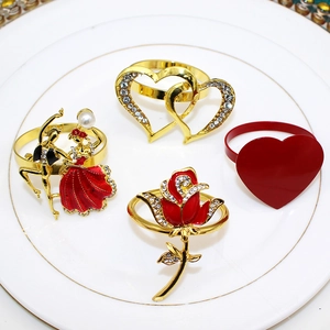 Detail of elegant heart and rose napkin rings with rhinestones on a white ceramic plate