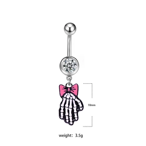 Detailed view of skull hand belly ring with pink bow and 18mm pendant size specifications