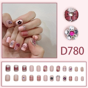 Pink press-on nails with bow, flower, and heart patterns in short square shape