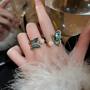 Gold-plated butterfly ring with abalone shell, freshwater pearl, and zircon stones