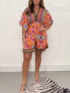 Detailed front view of women's V-neck romper with colorful bohemian geometric print patterns