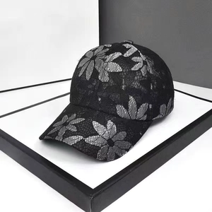 Black lace baseball cap with floral pattern and rhinestone butterfly detail