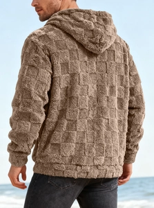 Close-up of brown textured fleece hoodie with embroidery on beach back view