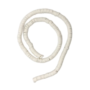 Macro view of white Heishi clay beads in a spiral arrangement for DIY jewelry projects