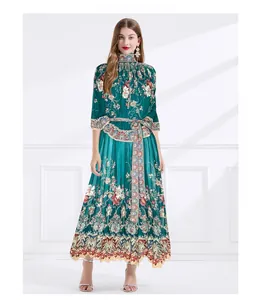 Detail of floral print pleated maxi dress with high neck and waist tie in dark green