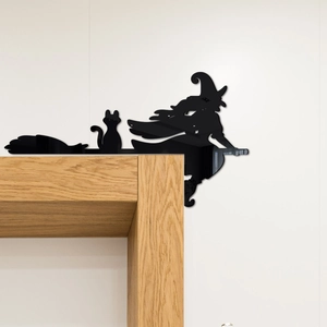Corner detail of black acrylic witch and cat silhouette sticker for Halloween decor