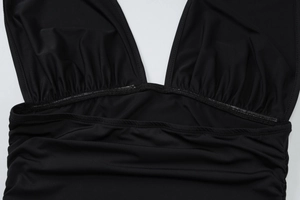 Close-up of black elastic fabric detailing smooth texture and V-neck stitching quality