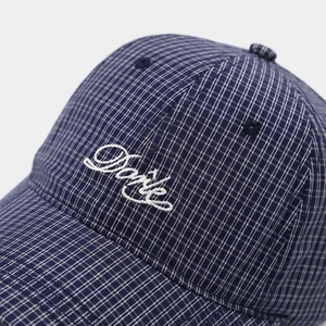 Navy and white checkered baseball cap with white script embroidery in a studio view