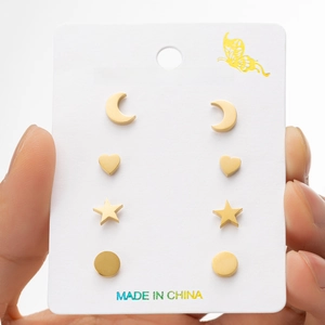 Set of four gold stainless steel stud earrings featuring star, moon, and heart designs